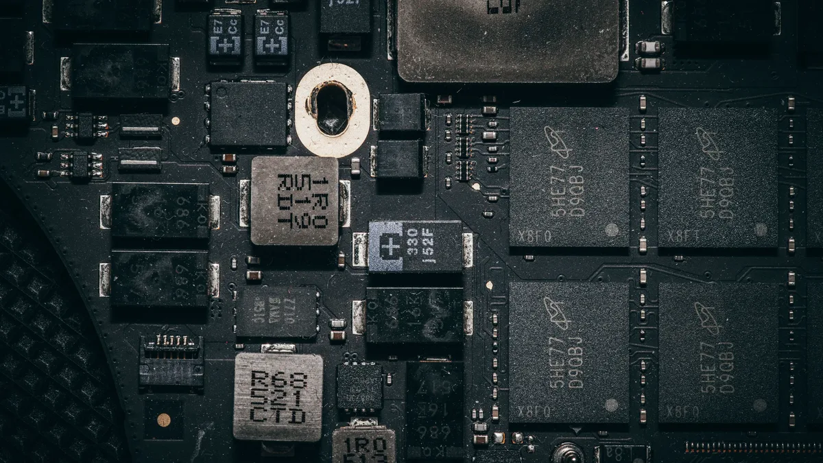 A collection of various electronic components, including microchips, capacitors, and resistors, arranged on a circuit board.